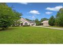 A single-Gathering home with a charming front porch and detached garage on a lush green lawn at 2333 Old Newnan Rd, Carrollton, GA 30116