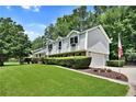 Well-maintained home featuring vinyl siding, an attached garage, and a manicured front lawn at 3107 Bunker Hill Cir, Marietta, GA 30062