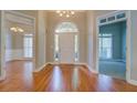 Spacious foyer with gleaming hardwood floors and open views to the dining and living areas, perfect for entertaining at 1065 Chippewa Oak Dr, Dacula, GA 30019