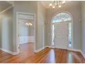 Bright foyer with gleaming hardwood floors, a chandelier, and a view into the adjacent dining room, creating an open entry at 1065 Chippewa Oak Dr, Dacula, GA 30019