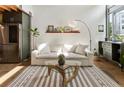 Bright living room with a soft white couch, glass table, and a stylish rug at 1661 La France Ne St # 222, Atlanta, GA 30307