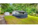 The property features a shed, nice lawn, and mature landscaping at 1841 Mobley St, Austell, GA 30106