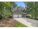 Well-maintained home featuring a two-car garage and mature trees at 110 Windsor Chase Dr, Lawrenceville, GA 30043