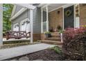 Charming front porch featuring a cozy swing and brick accents at 110 Windsor Chase Dr, Lawrenceville, GA 30043