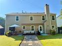 Spacious backyard featuring an outdoor patio with comfortable seating and a barbecue grill at 5388 Silver Springs Dr, Sugar Hill, GA 30518