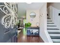 Elegant foyer with hardwood floors, stylish decor, and staircase at 5388 Silver Springs Dr, Sugar Hill, GA 30518
