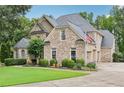 Beautiful brick home with attached garage, manicured lawn and an American flag at 219 Deer Park Trl, Canton, GA 30114