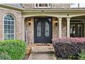 Elegant entryway with ornate wrought iron double doors and brick detailing at 219 Deer Park Trl, Canton, GA 30114
