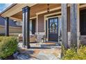 Inviting front porch with stone accents, wood pillars, and cozy seating creating a welcoming entrance at 266 Hanover Dr, Villa Rica, GA 30180