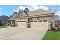 The home features a spacious three-car garage with convenient driveway access and well maintained landscaping at 266 Hanover Dr, Villa Rica, GA 30180