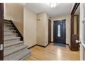 Inviting foyer featuring hardwood floors, a staircase, and a paneled front door at 3082 Briarleaf Dr, Decatur, GA 30034