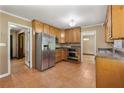 Functional kitchen featuring tile floors, wood cabinets, and stainless steel appliances at 3082 Briarleaf Dr, Decatur, GA 30034