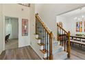 Carpeted staircase with wood and black iron banister leading to the upper level of the home at 1667 Willow Way, Woodstock, GA 30188