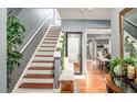 Inviting foyer with hardwood floors, staircase, and stylish decor at 338 Saratoga Pl, Riverdale, GA 30296