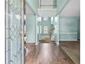 Inviting foyer with hardwood flooring, an elegant glass front door, and a view of the staircase at 750 Ambrose Ln, Atlanta, GA 30349