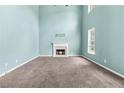Open living room with high ceilings, a fireplace, and lots of natural light from multiple windows at 750 Ambrose Ln, Atlanta, GA 30349