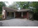 This brick home features a covered back entrance and an inviting side yard at 1102 Rogeretta Ne Dr, Atlanta, GA 30329