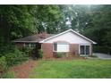 Charming brick home with bay window, sliding glass door, and green grass at 1102 Rogeretta Ne Dr, Atlanta, GA 30329