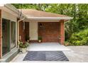A close-up of the covered front entrance featuring brick columns and neutral paint at 1102 Rogeretta Ne Dr, Atlanta, GA 30329