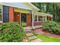 Inviting front porch with brick facade, iron railings, and landscaped pathway at 2233 Clairmont Ne Rd, Atlanta, GA 30329