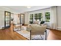 Bright living room featuring hardwood floors, large windows, and stylish furnishings at 2233 Clairmont Ne Rd, Atlanta, GA 30329