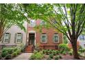 Charming two-story brick home with manicured landscaping and inviting front entrance and neutral shutters at 827 Perennial Dr, Atlanta, GA 30328