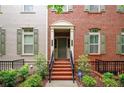 Inviting two-story brick home with manicured front yard and welcoming front porch and neutral shutters at 827 Perennial Dr, Atlanta, GA 30328