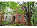 Charming two-story brick home with manicured landscaping and inviting front entrance and neutral shutters at 827 Perennial Dr, Atlanta, GA 30328