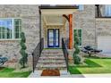 Close up of the front door with brick steps and a manicured yard at 1169 Dorby Park Ne Dr, Brookhaven, GA 30319