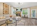 Comfortable living room featuring a stone fireplace, modern lighting, and stylish decor at 364 Mossycup Dr, Fairburn, GA 30213