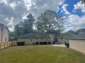 Back exterior of the home, displaying the large backyard with lush green grass at 3845 Pebble Beach Dr, Atlanta, GA 30349