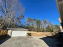 Large backyard with a detached garage and wooden privacy fence at 3845 Pebble Beach Dr, Atlanta, GA 30349