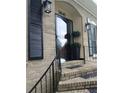Inviting front door with decorative black shutters and beautiful brick facade at 3845 Pebble Beach Dr, Atlanta, GA 30349