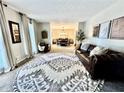 Bright living room with a large decorative rug, a leather sofa and lots of natural light at 3845 Pebble Beach Dr, Atlanta, GA 30349