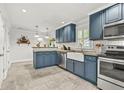Stylish kitchen boasts custom cabinetry, stainless appliances, a farmhouse sink and ample countertop space at 877 Mclendon Dr, Scottdale, GA 30079