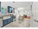 Bright kitchen featuring shaker cabinets, stainless steel appliances, and an adjacent dining area at 877 Mclendon Dr, Scottdale, GA 30079