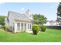 Lovely backyard showing the rear exterior with mature landscaping and double doors at 1460 Chamirey Sw Dr, Marietta, GA 30008