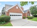 This is a beautiful view of the left side of the brick home and attached white two-car garage at 1460 Chamirey Sw Dr, Marietta, GA 30008