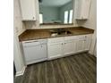 Updated kitchen featuring a stainless steel sink, tile countertops, and modern white cabinets at 3609 Ginnis Rd, Atlanta, GA 30331
