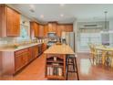 Spacious kitchen with center island, stainless appliances, and an adjoining dining area at 557 Pringle Dr, Suwanee, GA 30024
