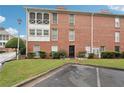 Front exterior of a brick condominium with manicured lawn and mature landscaping at 1166 Booth Sw Rd # 301, Marietta, GA 30008