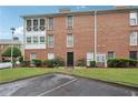 Brick condo with a well-manicured lawn and mature shrubs, showing a welcoming front entrance at 1166 Booth Sw Rd # 301, Marietta, GA 30008