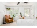 Bright and airy bedroom with neutral decor, chair, indoor plants, and large windows at 1348 Sheffield Glen Ne Way # 8, Atlanta, GA 30329