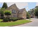 Corner lot home with a manicured lawn, lush greenery, and a two-car garage at 2459 Chestnut Lndg, Atlanta, GA 30360
