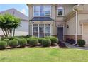Close-up of landscaped front yard with manicured bushes and lush green grass at 2459 Chestnut Lndg, Atlanta, GA 30360