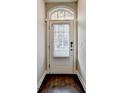 Inviting front door with sidelight and transom window, set against neutral walls and dark floors at 4232 Perimeter E Park # 110, Atlanta, GA 30341