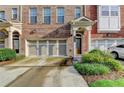 Brick townhome featuring a two-car garage and well-maintained landscaping at 4232 Perimeter E Park # 110, Atlanta, GA 30341