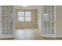 Bonus room with hardwood floors, natural light and double french doors at 4131 Carroll St, Covington, GA 30014