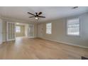 Inviting living room with hardwood floors, neutral walls, and glass doors leading to another room at 4131 Carroll St, Covington, GA 30014