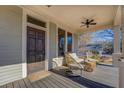 Charming covered porch featuring stylish seating, a ceiling fan, and a welcoming entrance at 5143 Floyd St, Covington, GA 30014